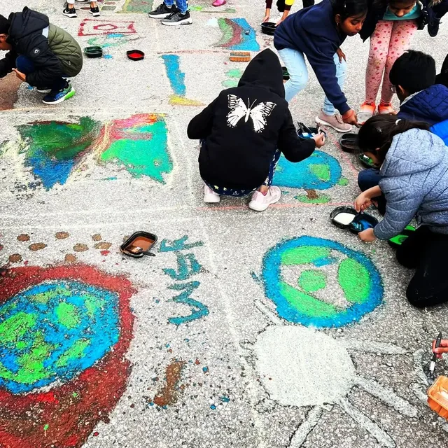 Children collaborating on pavement art