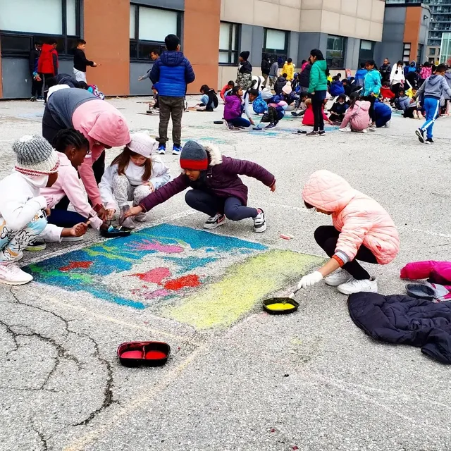 Children painting together at a community event